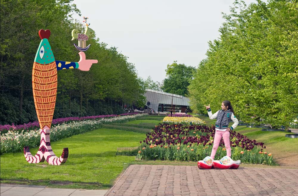 the sculpture The Salmon of Lugh and a young visitor imitating the Salmon